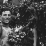 Spanish cyclist Delio Rodriguez , who won 12 of 21 stages at Vuelta in 1941 posing in front of a cheering crowd