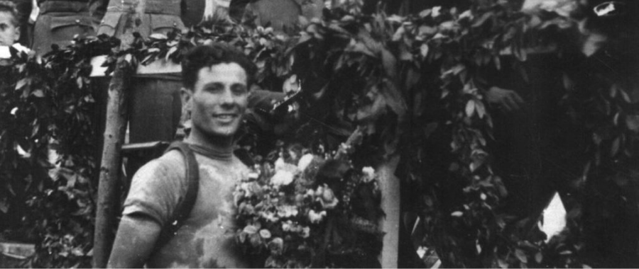 Spanish cyclist Delio Rodriguez , who won 12 of 21 stages at Vuelta in 1941 posing in front of a cheering crowd