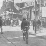 Cyclists arriving in a town during Tor de France 1904