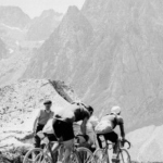 A group of cyclists in the front while Pyrenees in the background during Tour de France 1937