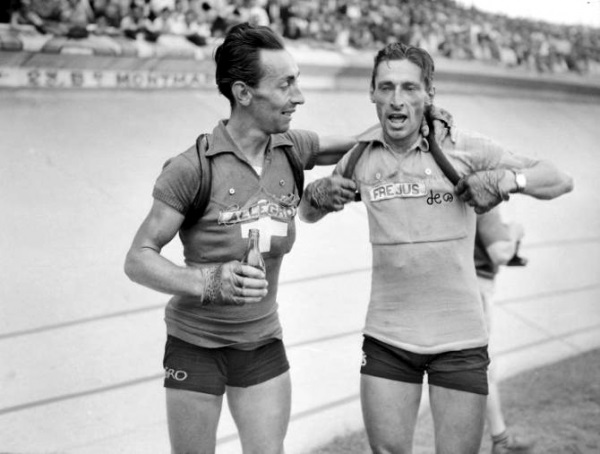 Swiss cyclist Emilio Croci-Torti in the Swiss national jersey embracijg his team captain Ferdi Kübler, who is wearing the famous yellow jersey at the Tour de France 1950